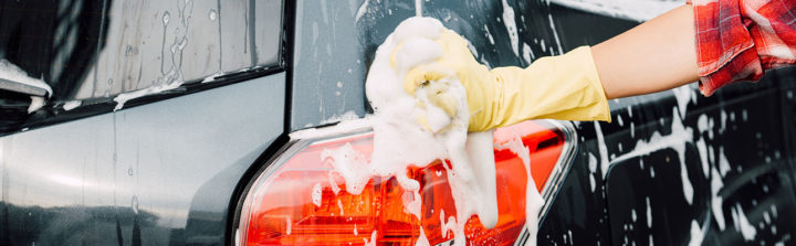 washing the car with soapy water and wearing protective gloves