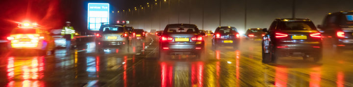 Window screen view of traffic ahead on a rainy motorway